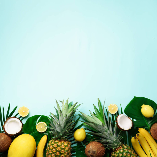 Экзотические ананасы, спелые кокосы, банан, дыня, лимон, тропические пальмы и листья монстров на синем фоне с копирайтом для текста. Квадратный. Креативная планировка. Летняя концепция. Плоский, вид сверху
 - Фото, изображение