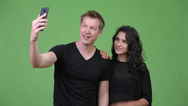 Young couple using phone together - Кадри, відео