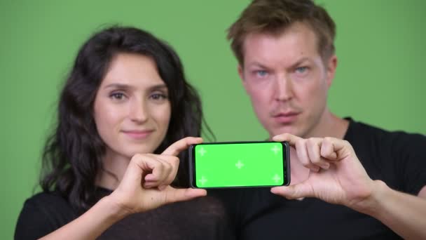 Young couple showing phone together - Felvétel, videó