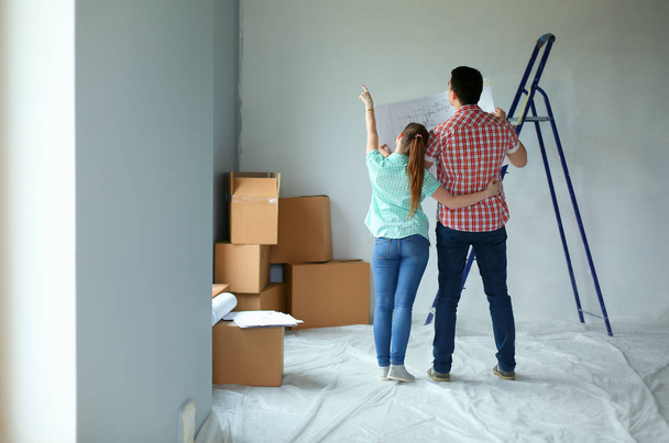 Portrait of young couple moving in new home. Young couple - Photo, image