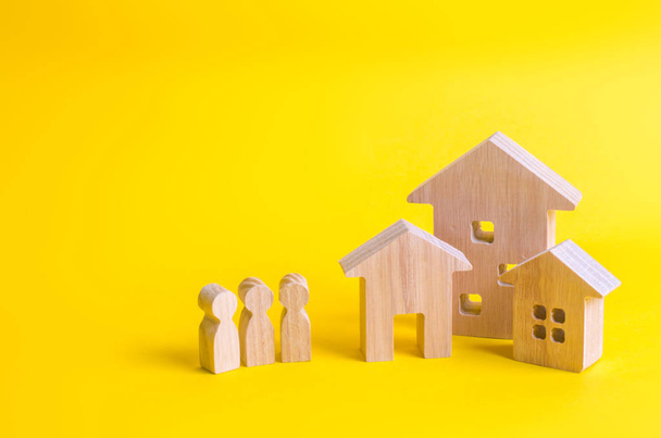 Three houses on a yellow background. Buying and selling of real estate, construction. Apartments and apartments. City, settlement. Minimalism. for presentations. real estate market. - Foto, imagen
