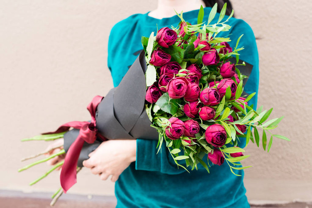 woman received a beautiful bouquet of bright pink peonies flower - Photo, image