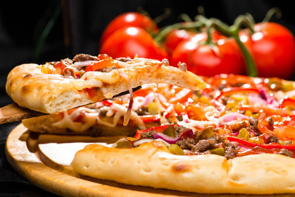 selective focus on piece of appetizing Italian pizza with meat,  - Photo, Image
