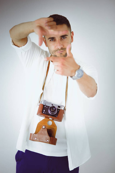 Young man with camera. Isolated over white background - Foto, Bild