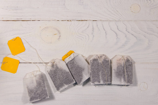 Tea bags on white wooden table. Top view - Photo, Image