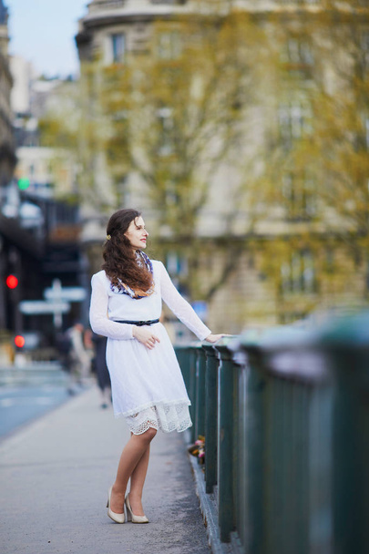 Young French woman in white dress on Bir-Hakeim bridge in Paris, France - Фото, зображення