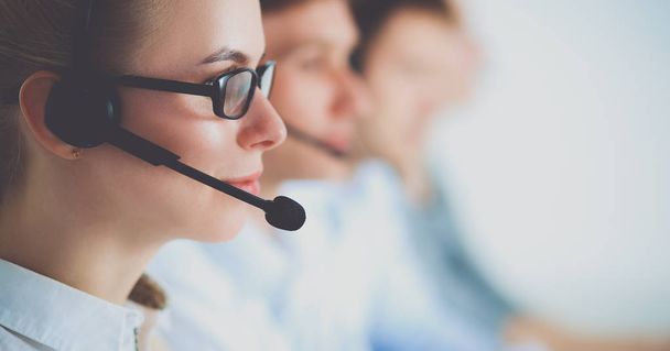 Attractive positive young businesspeople and colleagues in a call center office. - 写真・画像