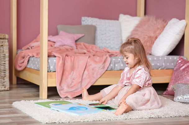 Cute little girl in princess dress reading book at home - Foto, Imagem