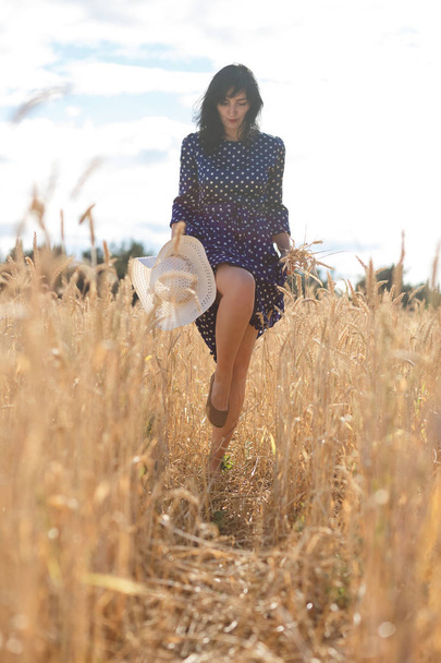 young beautiful brunette girl walking in the field - Фото, изображение