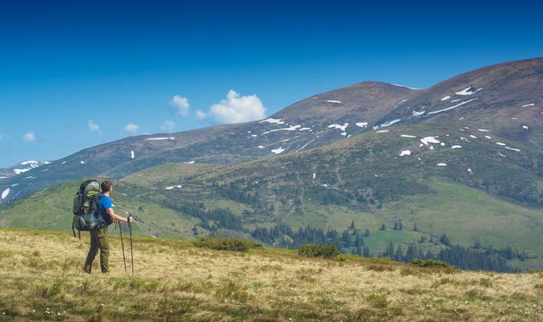 Man hiker with big expedition backpack in a high mountains. Carpathians, Ukraine, Europe. - Φωτογραφία, εικόνα