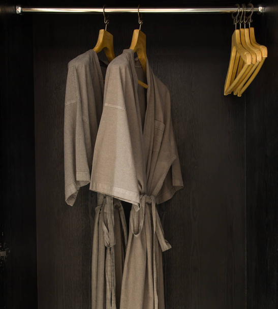  bathrobes hanging in wardrobe - Fotoğraf, Görsel