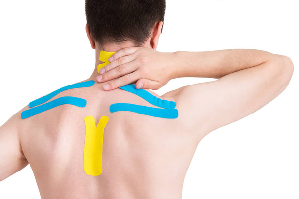 Kinesiology taping on human back, isolated on white background - Photo, Image