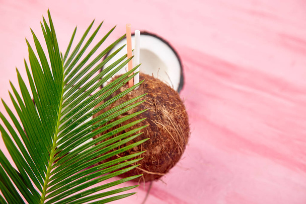 Kokosnusscocktail auf rosa Hintergrund. Sommerferiengetränk, tropische Cocktails oder Säfte in Kokosnuss. Kopierraum. Stillleben - Foto, Bild