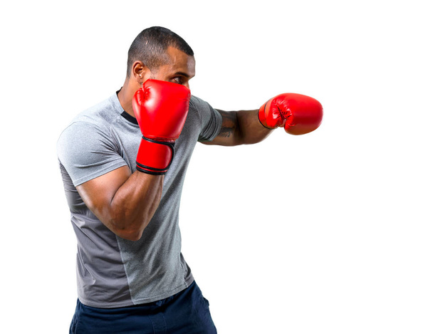 Strong sport man with boxing gloves fighting on isolated white background - Photo, Image