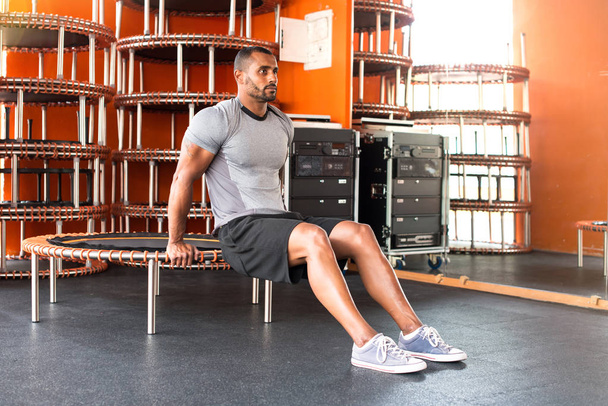 Sport homme dans la salle de gym avec saut du corps et échauffement
 - Photo, image