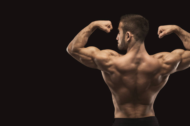 Unrecognizable man shows strong back muscles closeup - Φωτογραφία, εικόνα