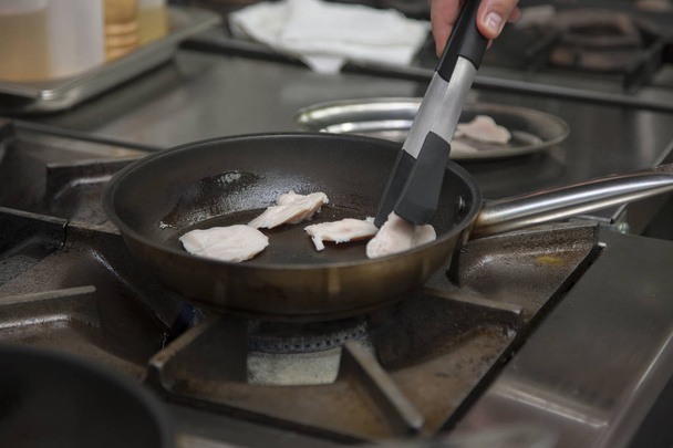 Hands cook, fry in a frying pan chicken Close-up - Foto, Imagen