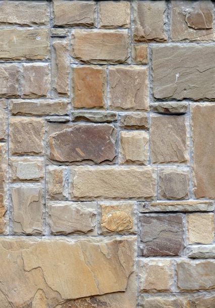 A wall lined with natural stone. - Foto, imagen