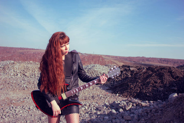 girl with guitar in leather jacket - Photo, Image