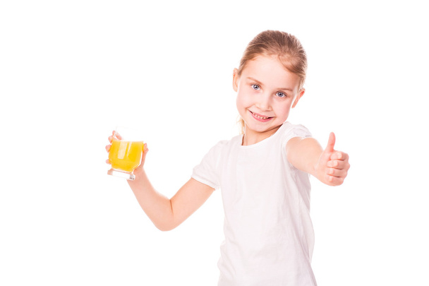 Cute little girl holding glass with juice smiling - Zdjęcie, obraz
