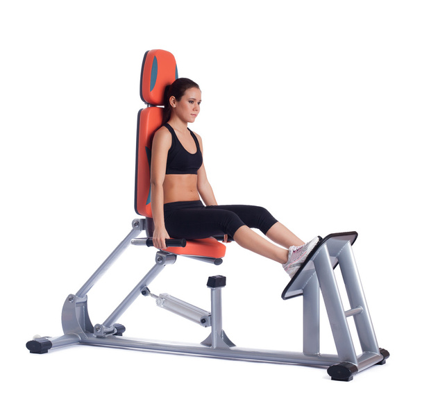 Young woman on hydraulic exerciser isolated - Foto, immagini
