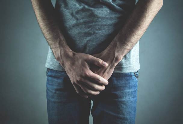 Caucasian man with hands holding his crotch. Inflammation of the prostate, erection problems - Photo, Image