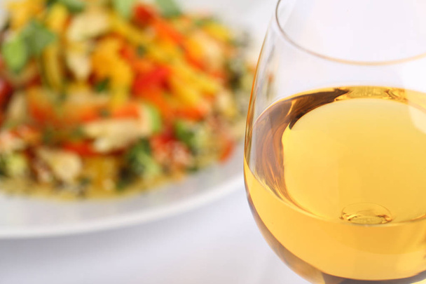 White wine glass and food background, vegetable salad - Zdjęcie, obraz