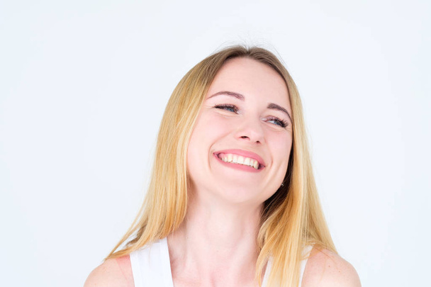 emotion face. very happy joyful thrilled to bits woman with beaming smile. young beautiful blond girl portrait on white background. - Foto, imagen