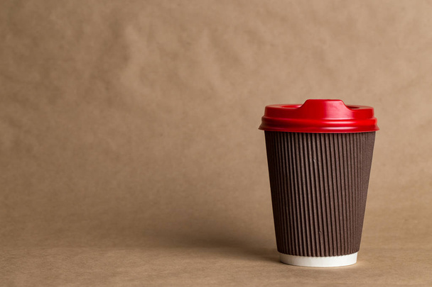 coffeeto  go in a disposable cup on a craft background, place for tex - 写真・画像