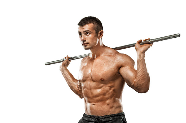 Brutal strong muscular bodybuilder athletic man pumping up muscles with barbell on white background. Workout bodybuilding concept. Copy space for sport nutrition ads. - Photo, Image