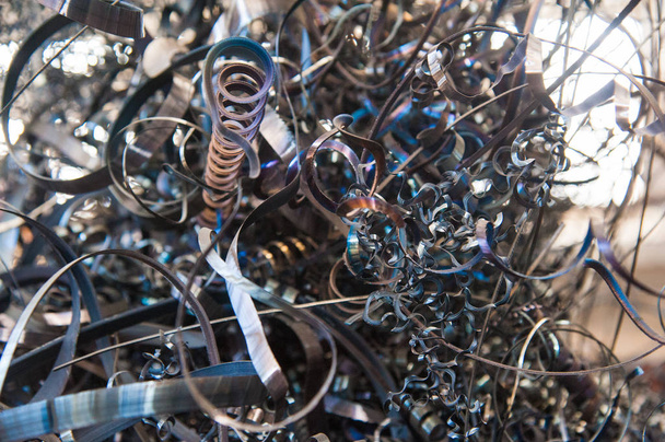 Closeup twisted spiral steel shavings. Scrap metal background - Foto, Imagem