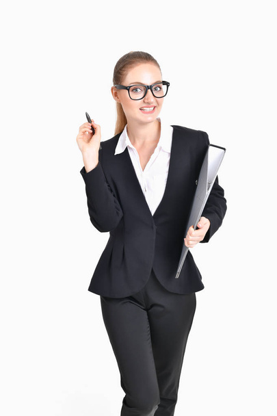 Business Concept. Beautiful businesswoman poses confidently. Young businesswoman pointing on copy space. Beautiful young businesswoman is presenting a job. - Valokuva, kuva