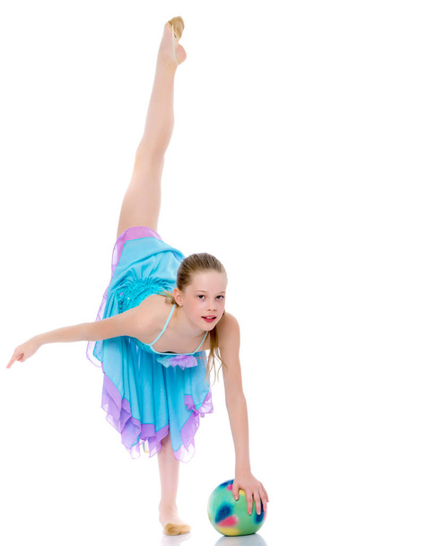 Girl gymnast performs exercises with the ball. - Φωτογραφία, εικόνα