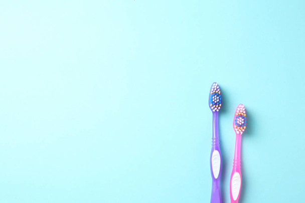 Manual toothbrushes on color background. Dental care - Fotoğraf, Görsel