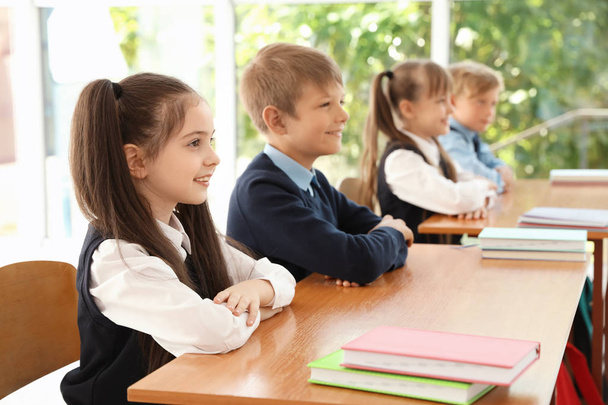 Little children in classroom. Stylish school uniform - Fotoğraf, Görsel