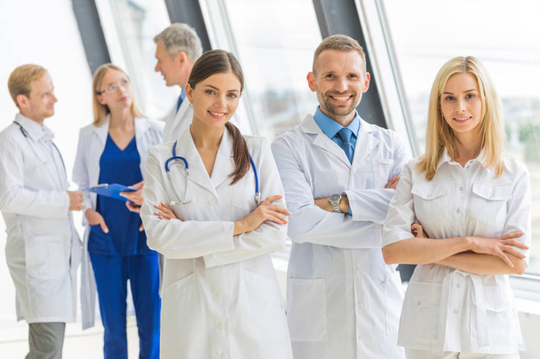 Medical team group portrait in hospital, people standing with arms crossed - Фото, изображение