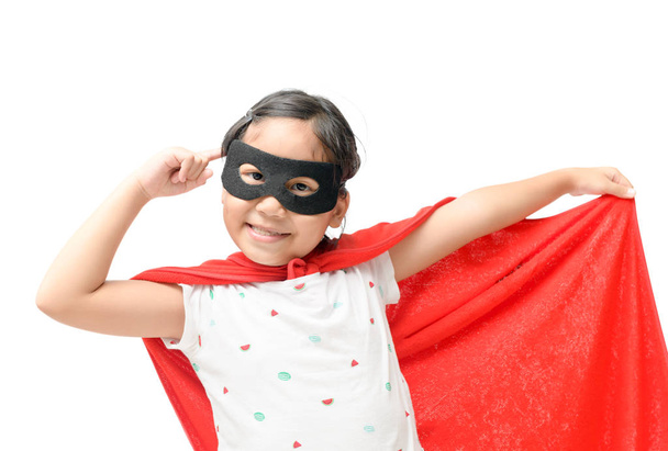 Little child plays superhero isolated on white background, Girl power concept. - Fotó, kép