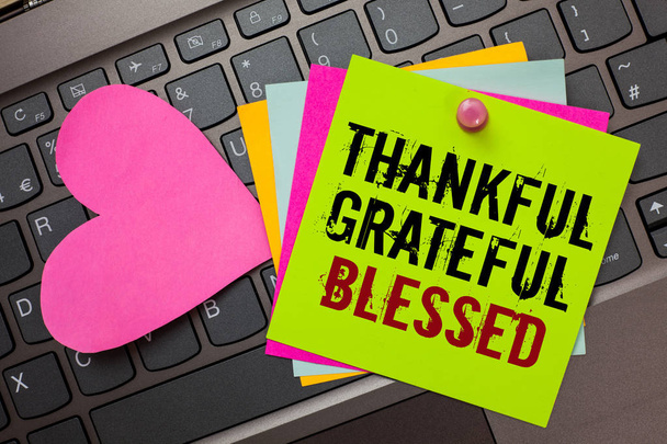 Text sign showing Thankful Grateful Blessed. Conceptual photo Appreciation gratitude good mood attitude Bright colorful written papers pinch by pin pink heart on computer keyboard - Photo, Image