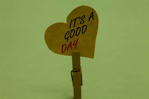 Handwriting text It s is A Good Day. Concept meaning Happy time great vibes perfect to enjoy life beautiful Celadon color background paper clip hold love heart for loving with words - Foto, imagen