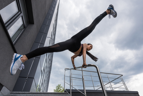 young asian sportswoman exercising on stairs at urban street - Photo, image