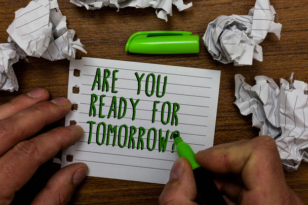 Word writing text Are You Ready For Tomorrow question. Business concept for Preparation to the future Motivation Hand hold green pen and words on white page paper lobs around on wooden desk - Photo, Image