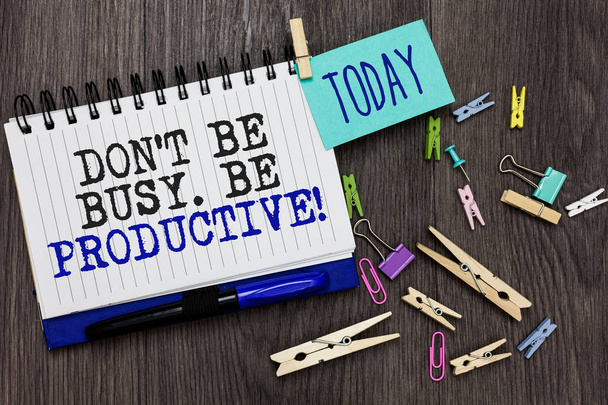 Writing note showing Don t not Be Busy. Be Productive. Business photo showcasing Work efficiently Organize your schedule time Different paperclip on woody table pinch on written notepad blue pen - Φωτογραφία, εικόνα