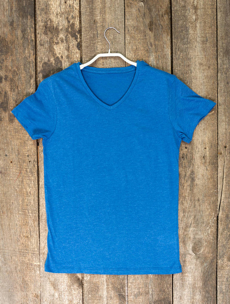 Basic cotton t-shirt on on wooden background - Foto, immagini