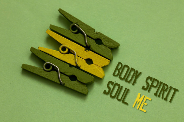 Handwriting text writing Body Spirit Soul Me. Concept meaning Personal Balance Therapy Conciousness state of mind Olive ground laid on paperclip in front some text of olive and yellow color - Photo, Image