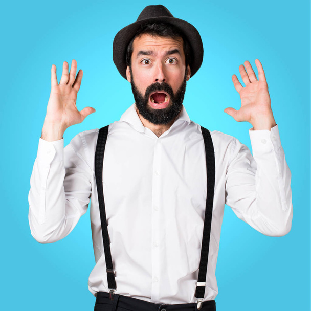 Surprised hipster man with beard on colorful background - Foto, imagen