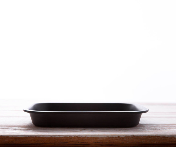 Empty baking tray for pizza close up on white wooden background top view square. Mock up for design - 写真・画像