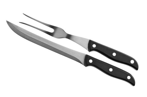 Biefstuk vork en mes op een witte achtergrond - Foto, afbeelding