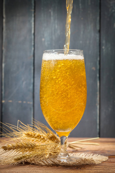 glass of fresh beer on rustic background - Fotó, kép