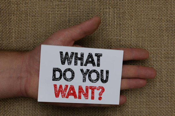 Writing note showing What Do You Want question. Business photo showcasing Tell me your desires requests demands ambition Human hand holding white page with black and red color texts on sack - Photo, Image