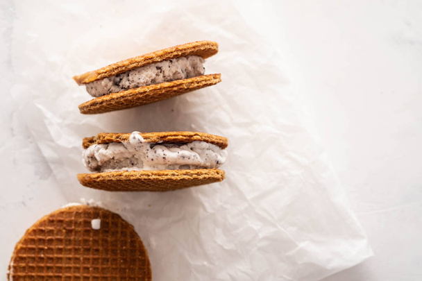 Stack of ice cream sandwiches with cookies isolated on a white background. Copy space. - Zdjęcie, obraz